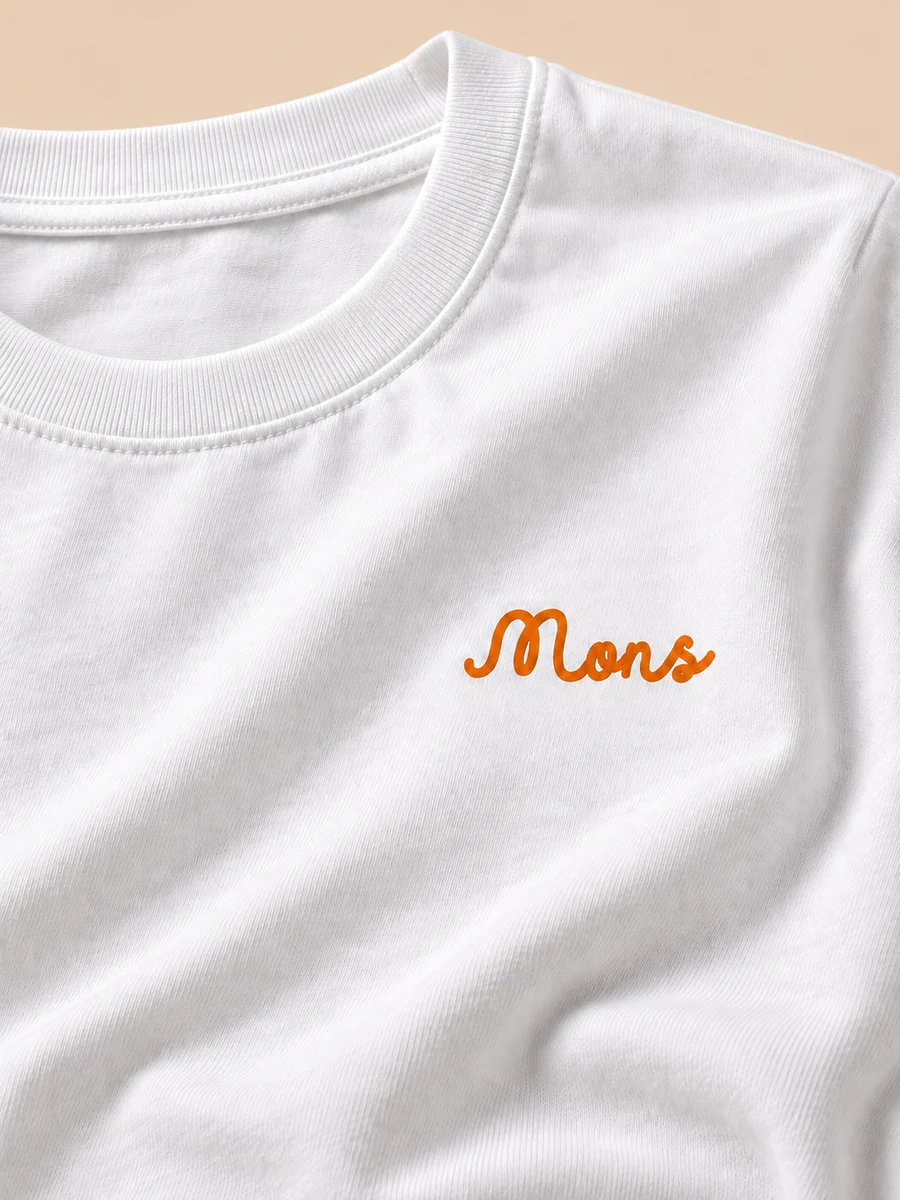 Close detail of the MONS orange script print on white cotton
